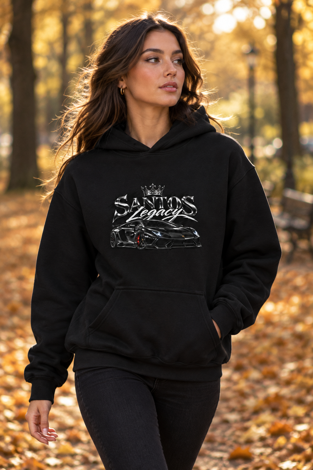Woman wearing the Santos Legacy Signature Premium Hoodie walking through an autumn park