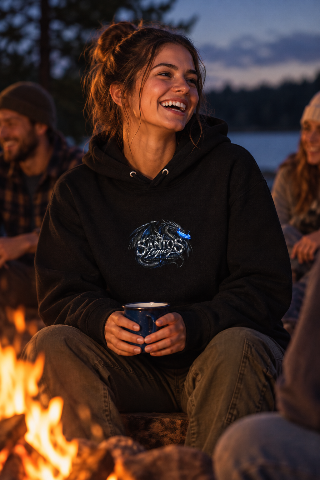 Woman wearing the Santos Legacy Signature Premium Unisex Hoodie laughing around a campfire