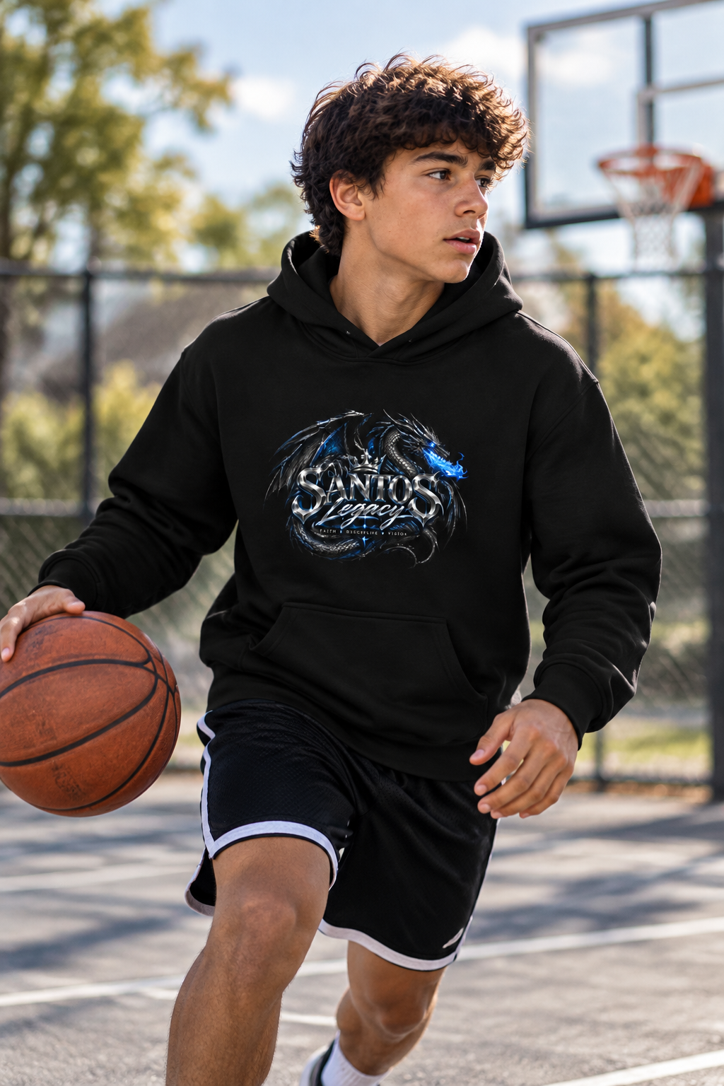 Teenage boy wearing the Santos Legacy Signature Premium Youth heavy blend hoodie at an outdoor basketball court