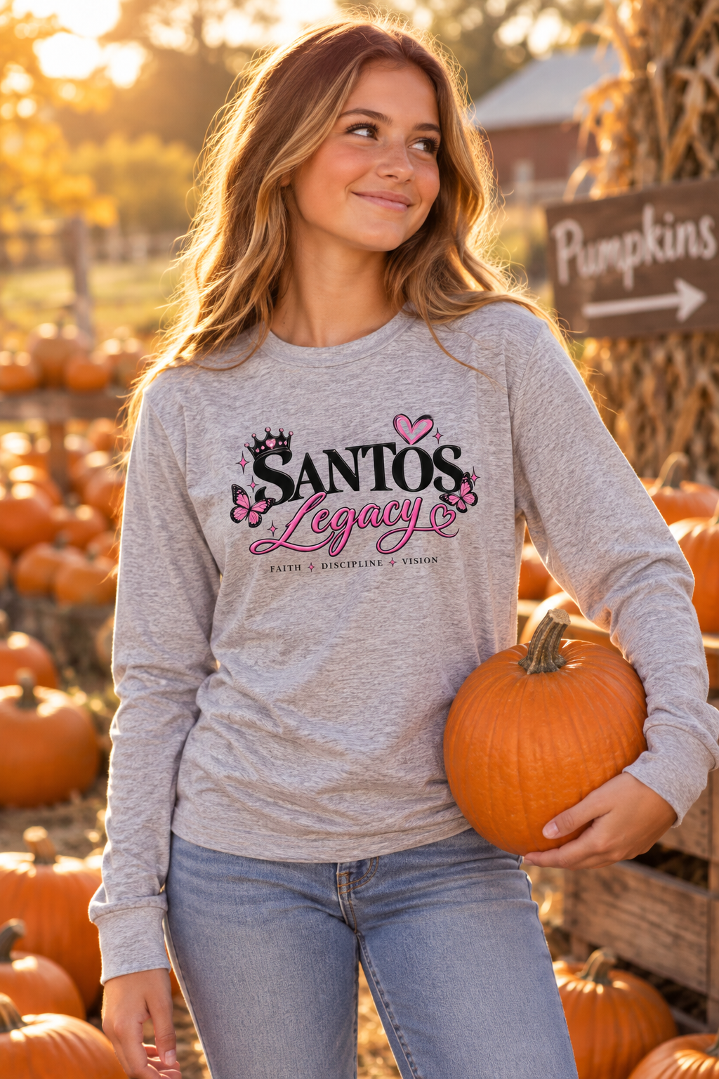 Teenage girl wearing the Santos Legacy Signature Premium Youth long sleeve tee at a fall pumpkin patch