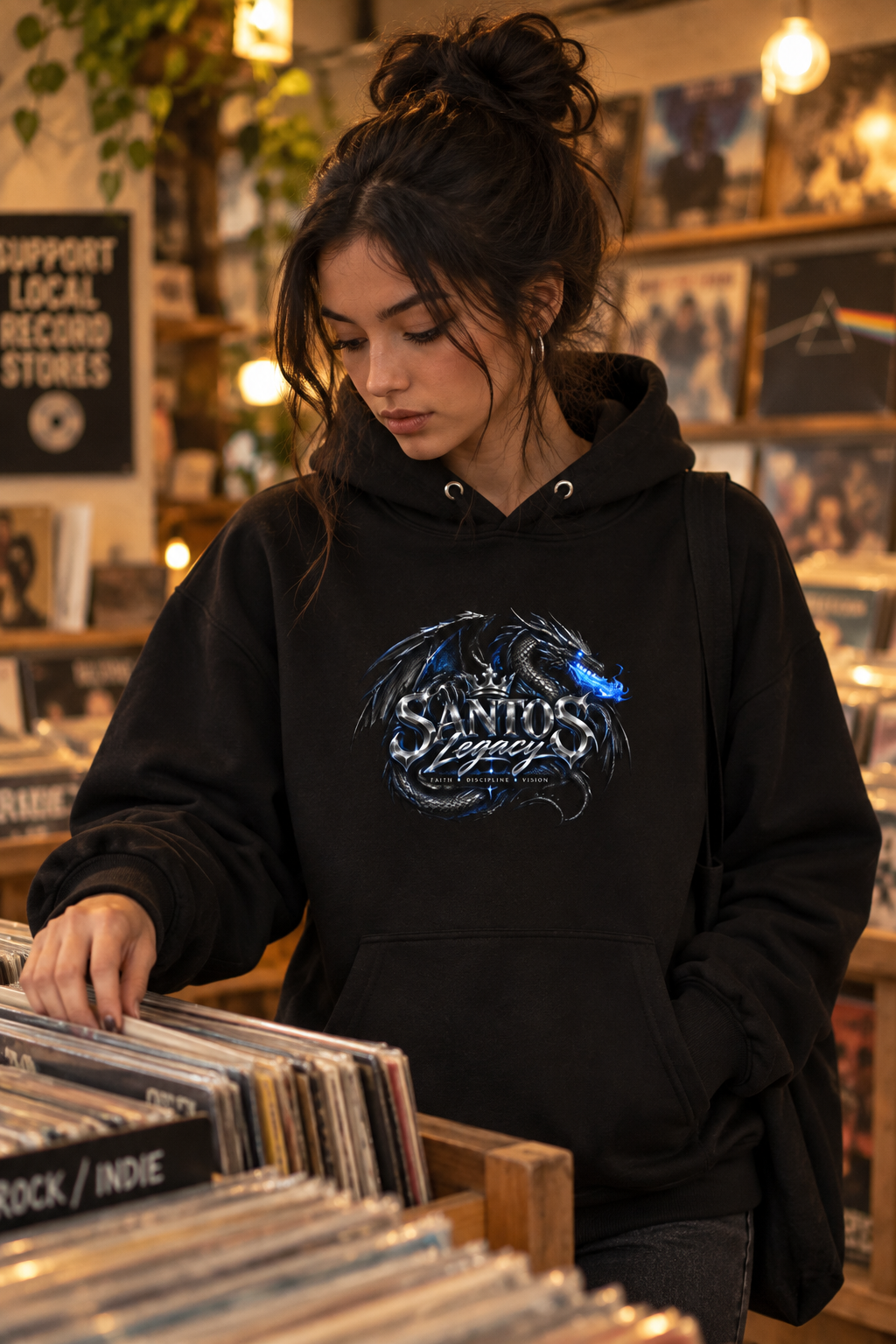 Woman wearing the Santos Legacy Signature Premium Hoodie browsing records in a vinyl store