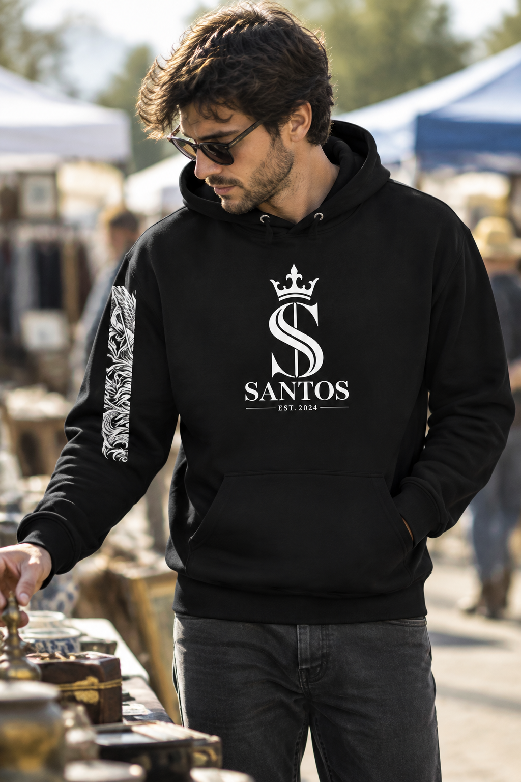 Man wearing the Santos Legacy Signature Premium Unisex Hoodie browsing a weekend flea market