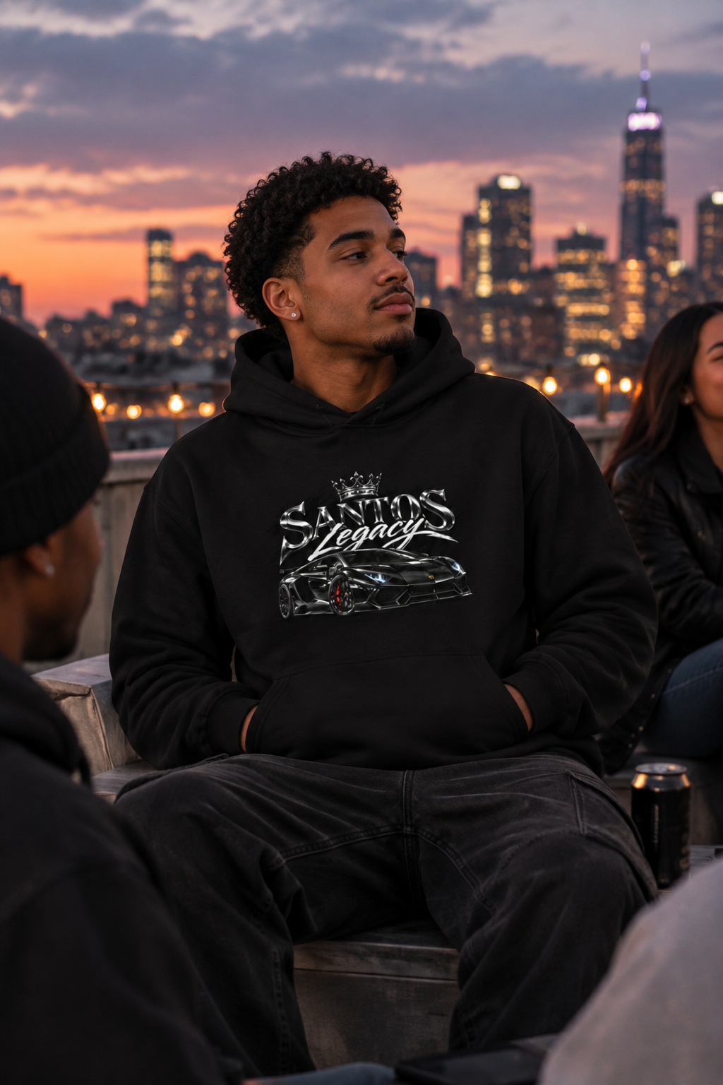 Man wearing the Santos Legacy Signature Premium Hoodie relaxing on a rooftop at dusk
