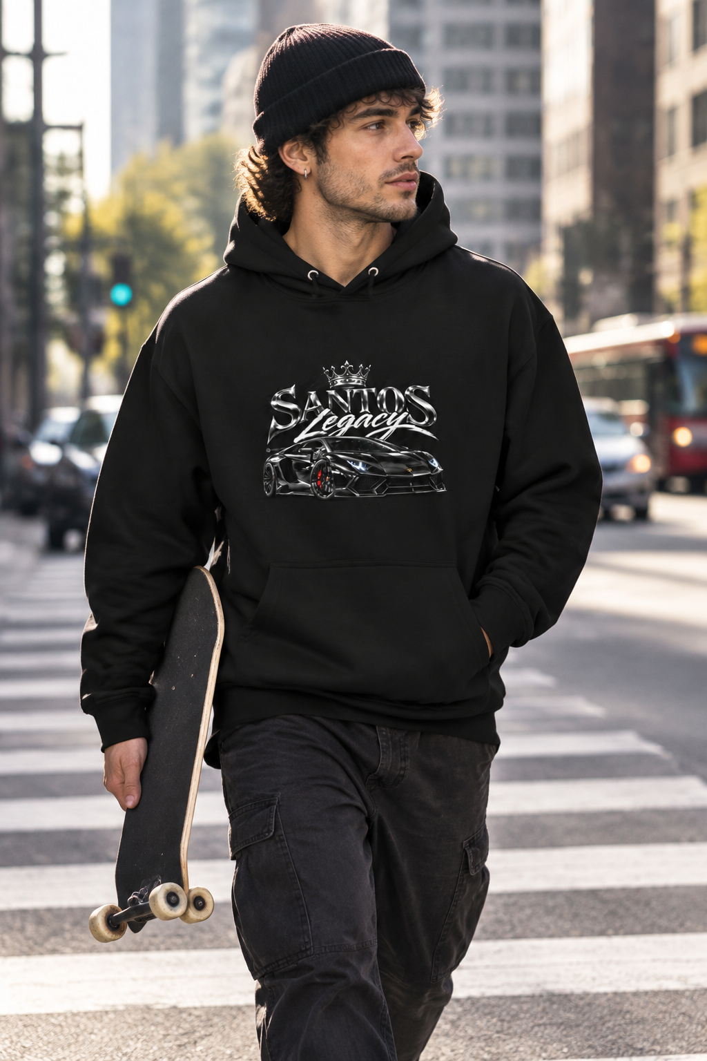Man wearing the Santos Legacy Signature Premium Unisex Hoodie carrying a skateboard through a downtown crosswalk
